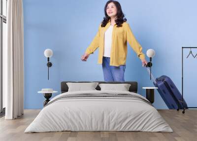 Full length image of middle aged Asian woman on background, summer concept Wall mural