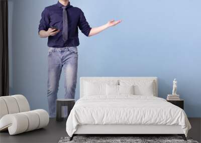 Full length image of young Asian businessman on blue background Wall mural