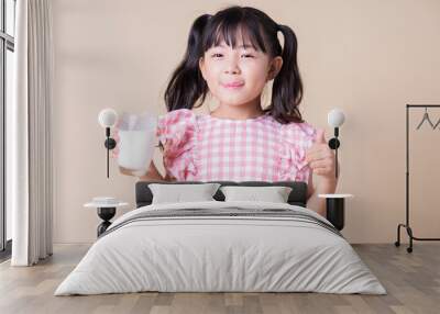 Image of Asian child drinking milk on background Wall mural