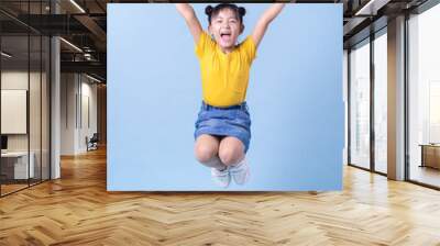 Image of Asian child posing on blue background Wall mural