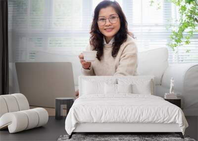 Image of senior Asian businesswoman working at home Wall mural