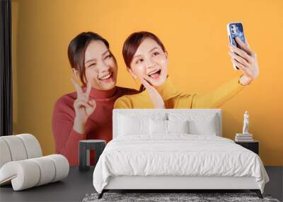 Image of two young Asian woman on background Wall mural