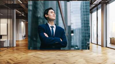 Image of Young asian businessman with glass building background Wall mural