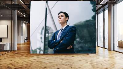 Image of Young asian businessman with glass building background Wall mural