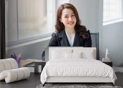 Image of young Asian businesswoman working at office Wall mural