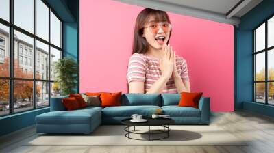 Image of young Asian girl wearing pink t-shirt on pink background Wall mural