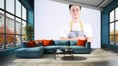 Image of young Asian waiter on background Wall mural