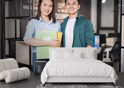 Photo of two young Asian business person working at office Wall mural