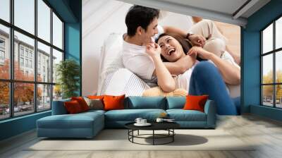 Photo of young Asian couple at home Wall mural