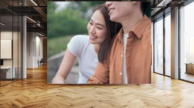 Photo of young Asian couple outside Wall mural