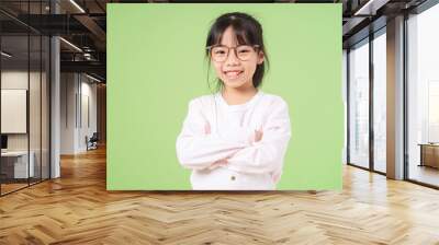 Portrait of Asian child on green background Wall mural