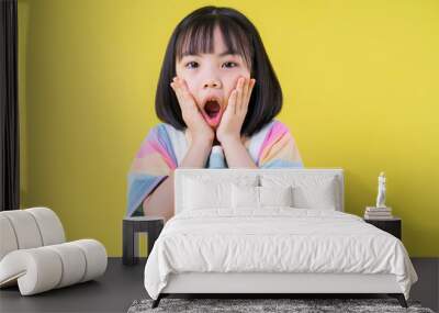 Portrait of Asian child on yellow background Wall mural