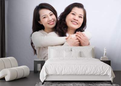 Portrait of Asian mother and daughter on white background Wall mural