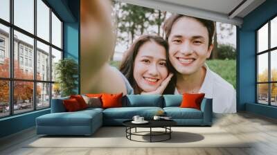 Portrait of young Asian couple outside Wall mural