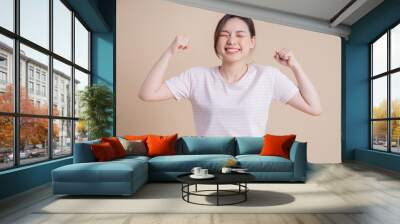 Portrait of young Asian girl posing on background Wall mural