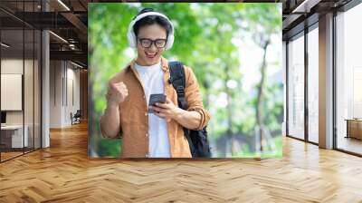 Portrait of young Asian man outside Wall mural