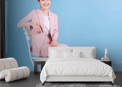 Young Asian business woman sitting on background Wall mural