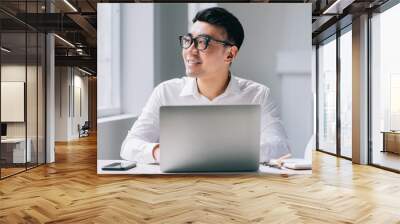 Young Asian businessman working at office Wall mural