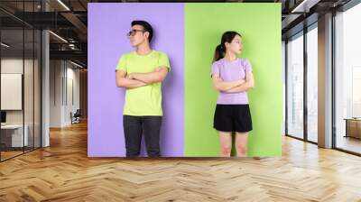 Young Asian couple arguing with each other, long distance love concept Wall mural