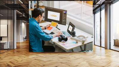 Young Asian designer working at office Wall mural