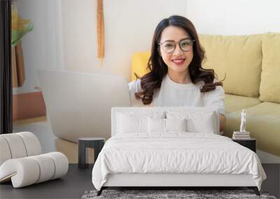 Young Asian woman working at home Wall mural