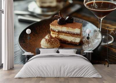 A beautifully arranged dessert plate featuring tiramisu, paired with a glass of espresso martini, on a dark wooden table Wall mural