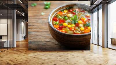 A steaming bowl of vegetable and quinoa soup, with colorful veggies floating in a rich, savory broth, set on a rustic wooden table Wall mural