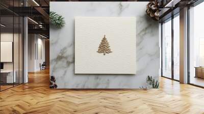 Minimalist Christmas card in neutral colors, with a small gold tree stamped in the center, resting on a marble surface. Wall mural