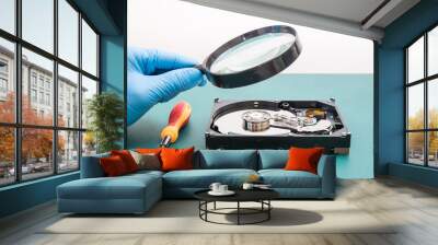 The abstract image of perspective inside of hard disk through a magnifying glass in the lab and green copy space is backdrop. the concept of data, hardware, technician and technology. Wall mural