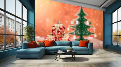 The abstract image of the small gift boxes on the table and the christmas tree is backdrop during snowing. the concept of festival, business, sales, gift, new year and christmas. Wall mural