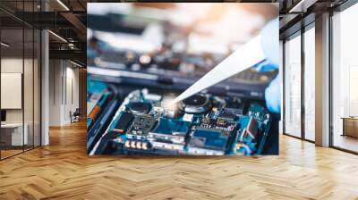 The asian technician repairing the smartphone's motherboard in the lab with copy space. the concept of computer hardware, mobile phone, electronic, repairing, upgrade and technology. Wall mural