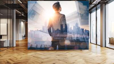 The double exposure image of the business man standing back during sunrise overlay with cityscape image. The concept of modern life, business, city life and internet of things. Wall mural