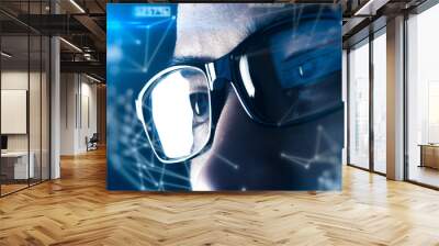 The double exposure image of the businessman wear a smart glasses overlay with futuristic hologram. The concept of modern life, technology, iris scanner and internet of things Wall mural