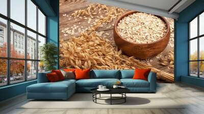 oat flakes in a bowl on the old board. Wall mural