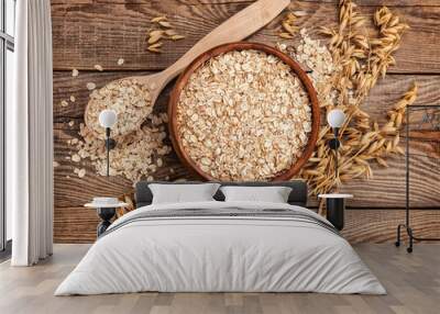 oatmeal in a bowl and spoon old board on top. Spikes of oats Wall mural