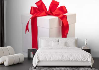 White gift box with red ribbon bow, isolated on white Wall mural