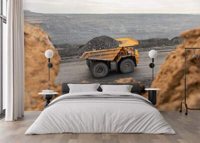 Large quarry dump truck. Big yellow mining truck at work site. Loading coal into body truck. Production useful minerals. Mining truck mining machinery to transport coal from open-pit production Wall mural