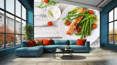 baked salmon garnished with asparagus and tomatoes with herbs. top view Wall mural