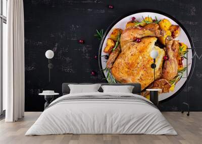 Baked turkey or chicken. The Christmas table is served with a turkey, decorated with bright tinsel. Fried chicken. Table setting. Christmas dinner. Top view Wall mural