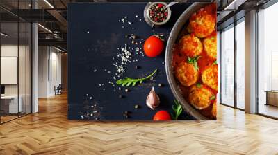 Chicken meatballs with tomato sauce in a pan. Dinner. Top view. Banner.  Dark background. Wall mural