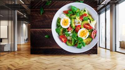 Fresh avocado salad with tomato, avocado, boiled eggs and fresh lettuce. Ketogenic diet breakfast.  Keto, paleo salad. Top view, overhead, above Wall mural