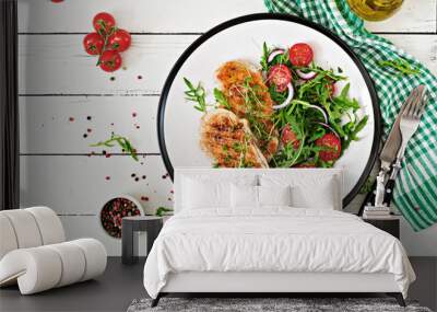 Grilled chicken fillet and fresh vegetable salad of tomatoes,red onion and arugula. Chicken meat salad. Healthy food. Flat lay. Top view. Wall mural