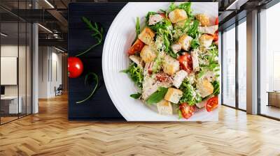 Healthy grilled chicken Caesar salad with tomatoes, cheese and croutons. North American cuisine. Top view Wall mural