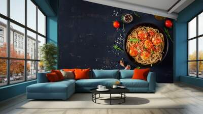 Italian pasta. Spaghetti with meatballs and parmesan cheese in black plate on dark rustic wood background.  Dinner. Top view. Slow food concept Wall mural