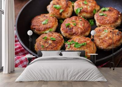 Juicy delicious meat cutlets in pan on a wooden table. Wall mural