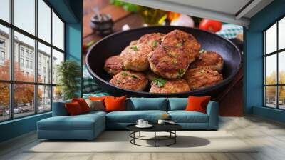 Juicy delicious meat cutlets in pan on a wooden table. Wall mural