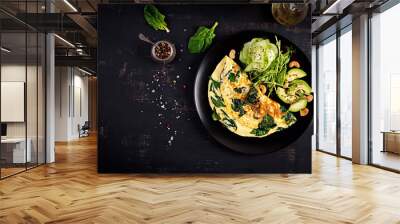 Ketogenic, paleo diet breakfast. Omelette with spinach and avocado, cucumber. Top view, copy space Wall mural