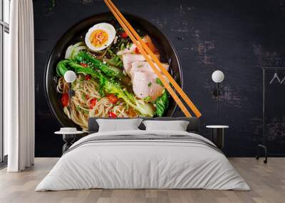 Miso Ramen Asian noodles with egg, pork and pak choi cabbage in bowl on dark background. Japanese cuisine. Top view. Flat lay Wall mural