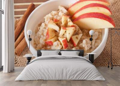 Oatmeal with apples and cinnamon in a white bowl  Wall mural