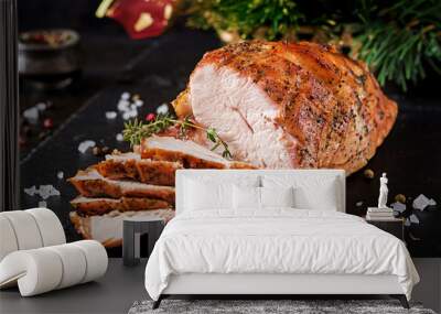 Roasted sliced Christmas ham of turkey on dark rustic background. Festival food. Wall mural